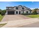 Two-story luxury home with attractive landscaping and a large driveway at 5222 Waterside Vista Ln, St Cloud, FL 34771