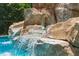 Close-up of cascading water feature in pool at 5222 Waterside Vista Ln, St Cloud, FL 34771