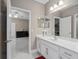Clean bathroom with white vanity and a large mirror at 5222 Waterside Vista Ln, St Cloud, FL 34771