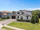 Two-story luxury home with attractive landscaping and a large driveway at 5222 Waterside Vista Ln, St Cloud, FL 34771
