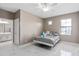 Cozy bedroom with white metal bed frame and adjacent bathroom at 5222 Waterside Vista Ln, St Cloud, FL 34771