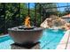 Relaxing pool with fire pit and waterfall feature at 5222 Waterside Vista Ln, St Cloud, FL 34771