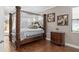 Main bedroom with four-poster bed, ensuite bathroom and backyard access at 5222 Waterside Vista Ln, St Cloud, FL 34771