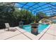 Resort-style pool with fire bowls and a rock waterfall at 5222 Waterside Vista Ln, St Cloud, FL 34771