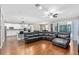 Open living room featuring a large sectional sofa and kitchen views at 5222 Waterside Vista Ln, St Cloud, FL 34771