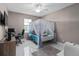 Bedroom with a canopy bed, desk and chair at 5222 Waterside Vista Ln, St Cloud, FL 34771