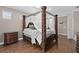 Main bedroom with a four poster bed and ensuite bathroom access at 5222 Waterside Vista Ln, St Cloud, FL 34771