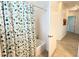 Simple bathroom with shower and patterned curtain at 709 Carmel Ln, Kissimmee, FL 34759