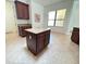 Kitchen island with granite countertop and dark wood cabinets at 709 Carmel Ln, Kissimmee, FL 34759