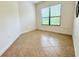 Empty room with neutral walls and tile flooring at 709 Carmel Ln, Kissimmee, FL 34759