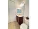 Bathroom with single vanity, toilet and large mirror at 709 Carmel Ln, Kissimmee, FL 34759
