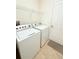 Laundry room with washer, dryer and shelving at 709 Carmel Ln, Kissimmee, FL 34759
