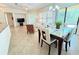 Dining area with glass-top table and chairs overlooking the living room at 709 Carmel Ln, Kissimmee, FL 34759