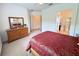 Spacious bedroom with ensuite bathroom and large dresser at 709 Carmel Ln, Kissimmee, FL 34759