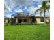 Spacious backyard with screened patio and lush landscaping at 709 Carmel Ln, Kissimmee, FL 34759