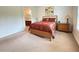 Main bedroom with carpeted floor and ensuite bathroom at 709 Carmel Ln, Kissimmee, FL 34759