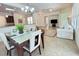 Casual dining area with glass-top table and seating for four, adjacent to kitchen at 709 Carmel Ln, Kissimmee, FL 34759