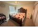 Bedroom with king-size bed, dresser, and crib at 2414 Fenetre Ln, Kissimmee, FL 34741