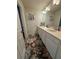 Clean bathroom with double vanity and floral rug at 2414 Fenetre Ln, Kissimmee, FL 34741