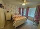Bedroom with full bed, dresser, and Eiffel Tower decor at 2414 Fenetre Ln, Kissimmee, FL 34741