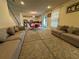 Spacious living room with gray sofas and large TV at 2414 Fenetre Ln, Kissimmee, FL 34741