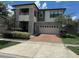 Two story house with stone accents and a brick driveway at 2414 Fenetre Ln, Kissimmee, FL 34741