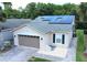 Single-story house with solar panels and a two-car garage at 561 Vineyard Way, Poinciana, FL 34759