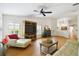 Light-filled living room featuring hardwood floors, fireplace and comfortable seating at 561 Vineyard Way, Poinciana, FL 34759