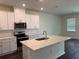 Modern kitchen with white cabinets, stainless steel appliances, and an island at 4422 Small Creek Rd # 72, Kissimmee, FL 34744
