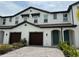 Two-story townhome with two-car garage and teal door at 4422 Small Creek Rd # 72, Kissimmee, FL 34744