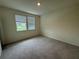 Bright bedroom with two windows and carpet flooring at 4422 Small Creek Rd # 72, Kissimmee, FL 34744