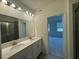 Bathroom features double sinks and access to bedroom at 4422 Small Creek Rd # 72, Kissimmee, FL 34744