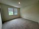 Bright carpeted bedroom with two windows at 4422 Small Creek Rd # 72, Kissimmee, FL 34744