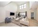 Spacious living room with high ceilings, a large sectional sofa, and lots of natural light at 2744 Bookmark Dr, Kissimmee, FL 34746