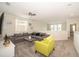Spacious loft area with gray sectional sofa and yellow accent chair at 2744 Bookmark Dr, Kissimmee, FL 34746