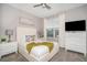 Bright bedroom with a queen-size bed, nightstands, and a large window at 2744 Bookmark Dr, Kissimmee, FL 34746