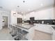 Modern kitchen with white cabinets, grey countertops, and stainless steel appliances at 2744 Bookmark Dr, Kissimmee, FL 34746