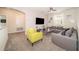 Comfortable living area with sectional sofa, a yellow accent chair, and a large TV at 2744 Bookmark Dr, Kissimmee, FL 34746