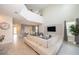 Open living room with a large sectional sofa, high ceilings, and a large TV at 2744 Bookmark Dr, Kissimmee, FL 34746
