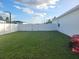 Large backyard with grassy area, white vinyl fence, and gate at 870 E 19Th St, Saint Cloud, FL 34769