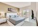 Main bedroom with a king-size bed, nightstands, and TV at 3227 Cupid Pl, Kissimmee, FL 34747