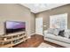 Bright living room featuring a comfy couch and flat-screen TV at 3227 Cupid Pl, Kissimmee, FL 34747