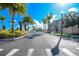 Landscaped entrance to the community with palm trees and a pergola at 3227 Cupid Pl, Kissimmee, FL 34747