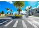 Landscaped entrance to the community with palm trees and a pergola at 3227 Cupid Pl, Kissimmee, FL 34747