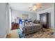 Elegant bedroom with brass bed frame, blue accents, and ample storage at 7459 Gathering Dr, Reunion, FL 34747