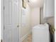 Bright laundry room with washer, dryer, and storage at 7459 Gathering Dr, Reunion, FL 34747