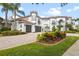 Mediterranean style home with tile roof and landscaping at 7459 Gathering Dr, Reunion, FL 34747