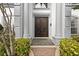 Grand entryway with double doors and stone pathway at 7459 Gathering Dr, Reunion, FL 34747