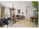 Elegant sitting room featuring a leather sofa, ornate coffee table, and large window at 7459 Gathering Dr, Reunion, FL 34747