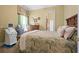 Spacious bedroom with a large bed, dresser, and window at 7459 Gathering Dr, Reunion, FL 34747